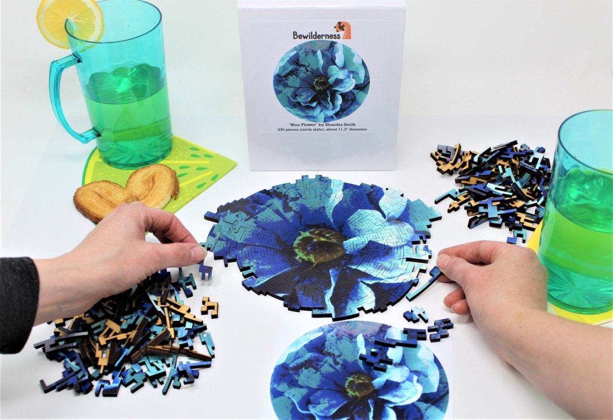 Two hands working together on Blue Flower puzzle