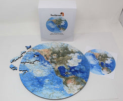 Earth wooden puzzle by Bewilderness, full puzzle and box with some pieces set aside